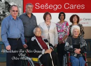 Mrs Grauso and Mrs Watkins receiving their wheelchairs from ABSA